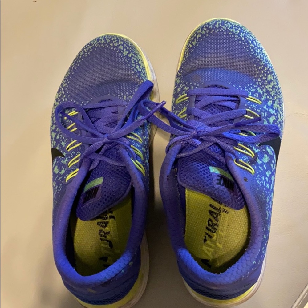 Used purple and green Nike free rn distance